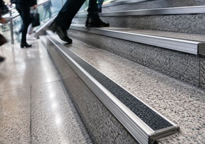 Anti-slip stair nosing fitted to commercial stairs in a high-traffic building